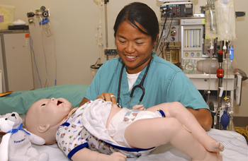 Practicing care on infant simulator © UC Regents