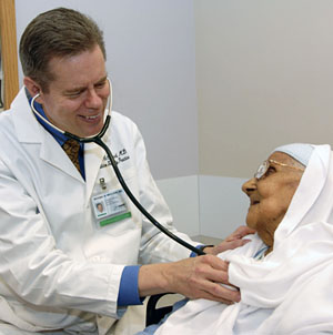 Dr. Michael McCloud with elderly patient © UC Regents