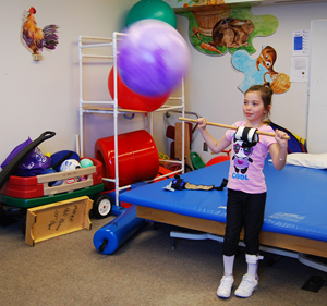 Precious plays with a ball during physical therapy © UC Regents
