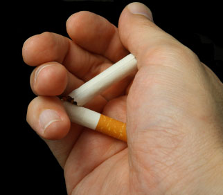 Photo of man's hand with broken cigarette © iStockphoto