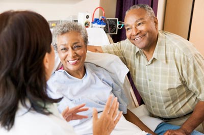 Doctor talking to patient and family member © iStockphoto