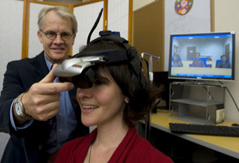 Peter Mundy adjusts virtualy reality device © 2010 UC Regents