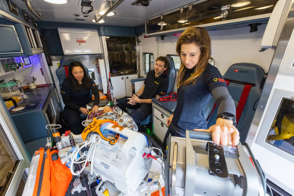 Pediatric transport team members inside ambulance