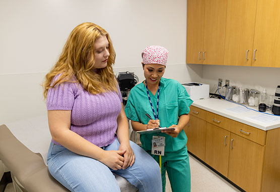 Female health care provider showing female patient some information on a paper 