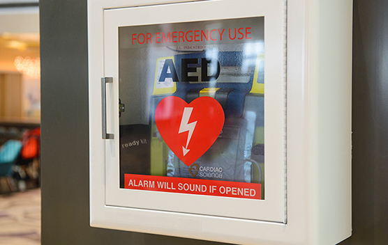 An AED machine mounted on a hospital wall