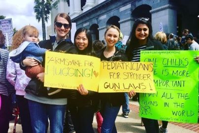 Residents hold up signs to protest gun violence at Sacramento capital.