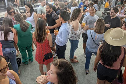 Residents enjoy outdoor happy hour with drinks and eats, music and crowds.