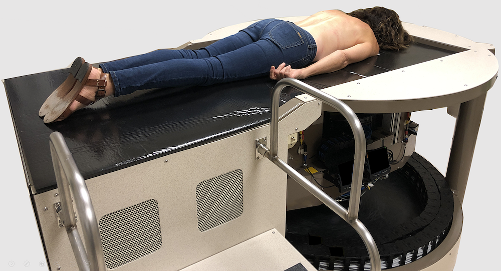 woman laying in breast imaging machine