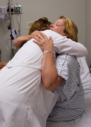 Physician hugging patient