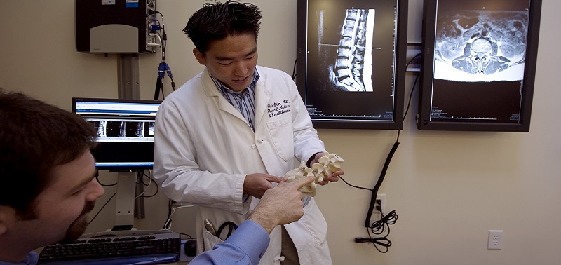 Doctor and patient discussing spine anatomy