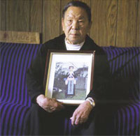 PHOTO -- Chong Yia Xiong of Stockton displays a photo of his late wife, Chou Vang, who died of cancer. UC Davis offers Hmong-speaking "navigators" to help families through cancer treatment 