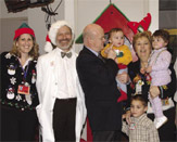PHOTO -- In Santa hat and white coat, Jonathan Ducore, head of the UC Davis Pediatric Cancer Program, celebrates with patients, colleagues and friends.