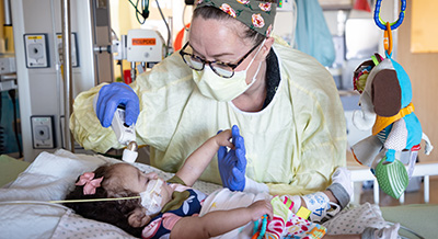 PICU nurse taking care of a pediatric patient
