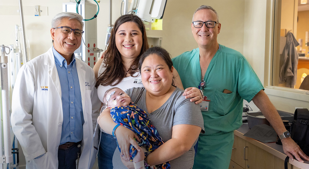 Frank Ing, M.D., chief of pediatric cardiology and Gary Raff, M.D., senior pediatric cardiothoracic surgeon with Elizabeth Vincent and son Carter after a successful cath procedure.