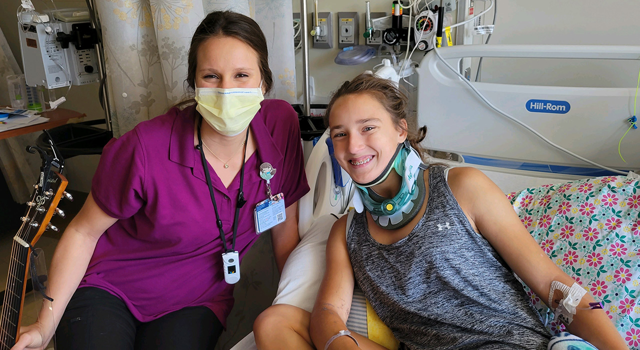 Pediatric trauma patient Julia and a nurse in the hospital after a tubing accident