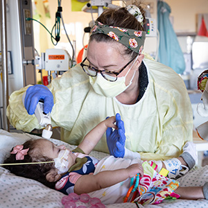 Pediatric Intensive Care nurse taking care of a patient