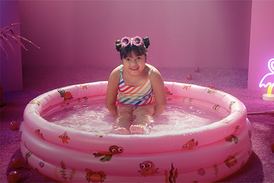 Audrey sitting in kiddie pool