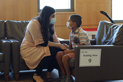 Mother and pediatric patient wait in reception area 9.