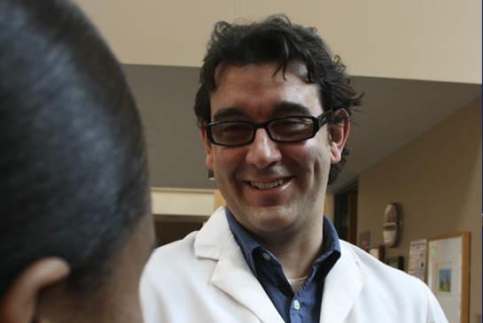 Faculty member talking with patient