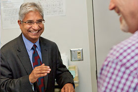 Surgical oncologist Vijay Khatri consults with a patient